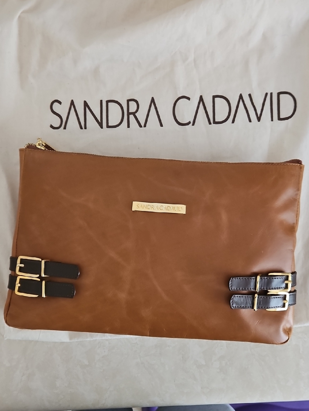 Sandra Cadavid Leather Clutch with Buckle Accents.